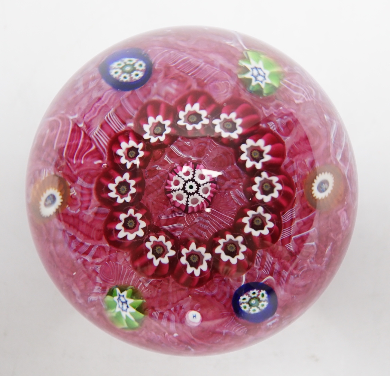 A Paul Ysart millefiori garland glass paperweight, Harland period, ‘H’ cane, with scrambled pink latticino ground, 6.5cm